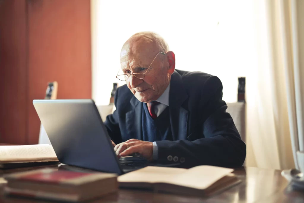 An old man using a laptop