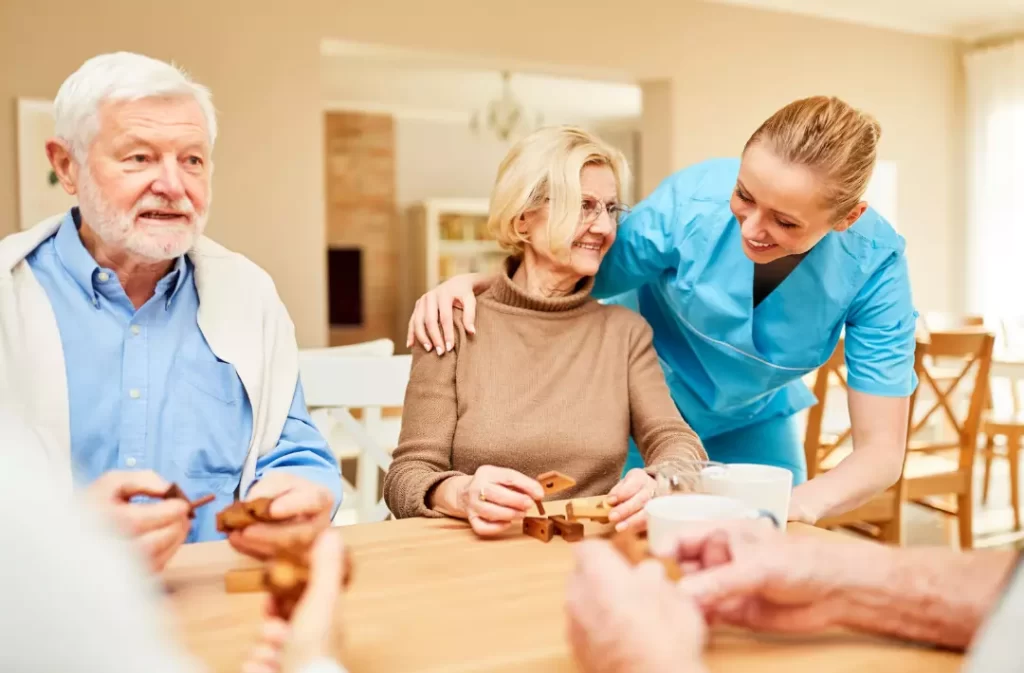 A carer cares for senior couple with dementia